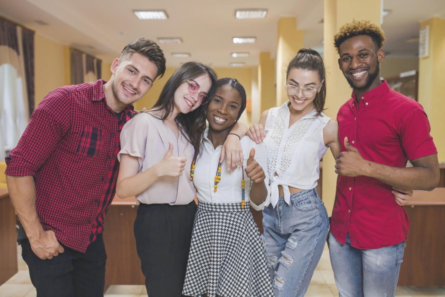 Person reviewing weekly budget documents at desk with laptop